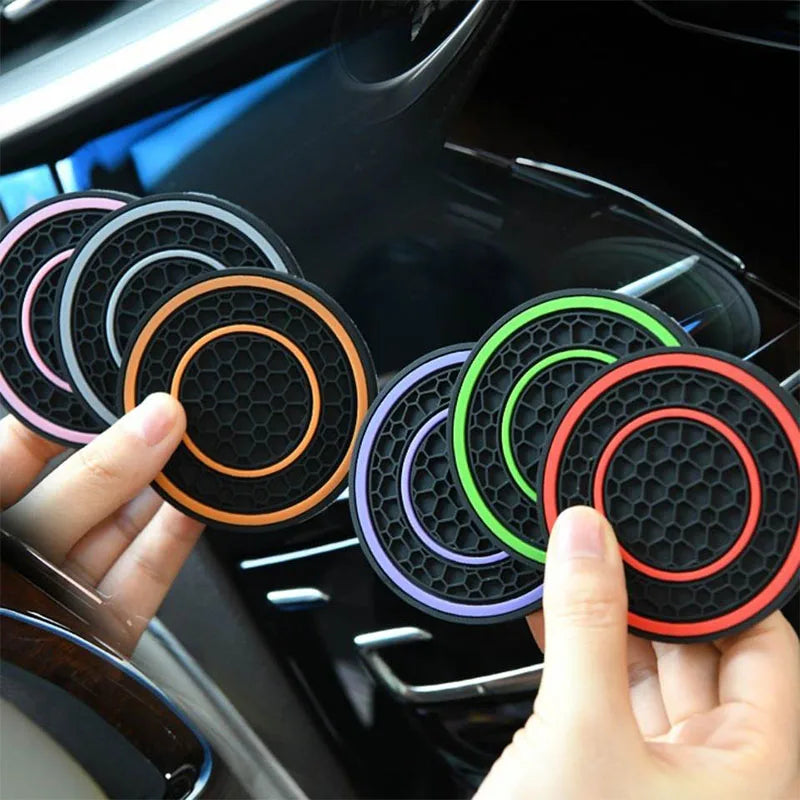Non-slip car cup holder coasters held in hand next to a center console